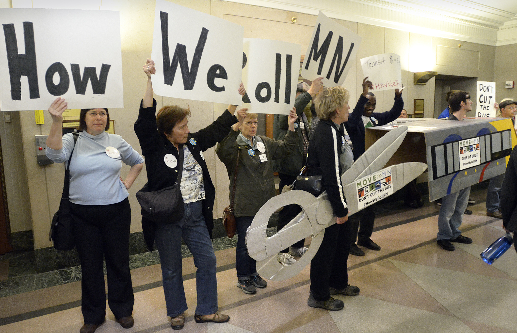 Advocates for public transportation demonstrate in the State Office Building April 16. Photo by Andrew VonBank